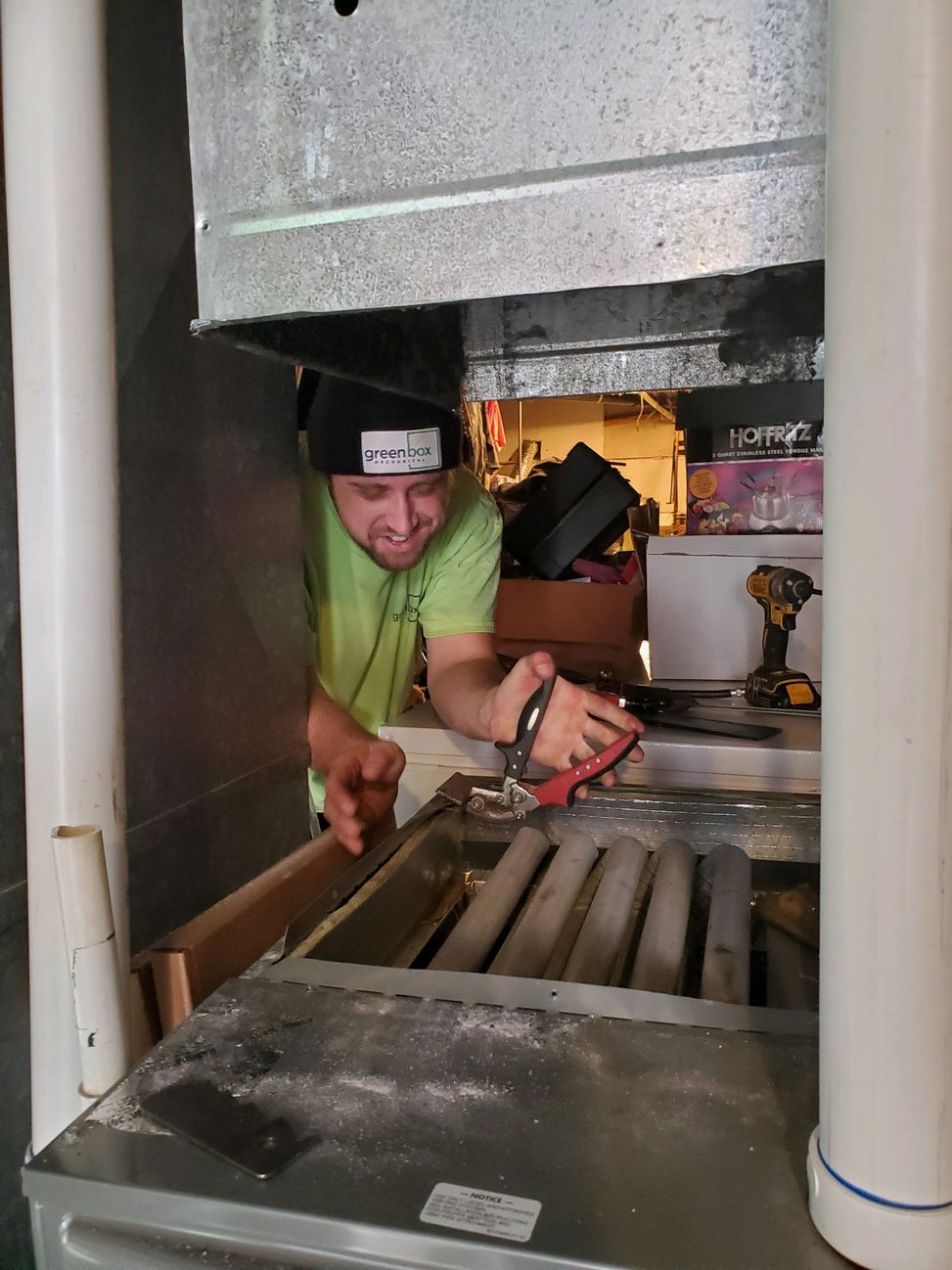Nic doing maintenance on a furnace